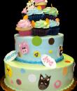 Cuddly Farm Birthday Cake. Green and blue buttercream iced, round 2 tiers decorated with the faces of farm animals, circles, dots, numbers and cupcakes. Everything on this cake is edible. (Serves 28-55 party slices.) 