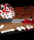 Friday the 13th Birthday Cake. Chocolate buttercream iced, blood splattered sheet cake, decorated with bones, a bloody machete, and Jason's bloody hockey mask. Everything on this cake is edible. (Serves 24 – 98 party slices)