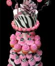Cupcakes and Pearls 1st Birthday Cake. Pink buttercream iced cupcakes and a white buttercream iced round top cake decorated with an edible zebra print wrap, pearls, balloons and a zebra pink rose. Everything on this cake is edible. 
