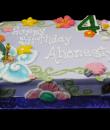 Tinker Bell 4th Birthday Cake, Lavender buttercream iced,  sheet cake, decorated with shells, butterflies, flowers and scrolls. everything on this cake is EDIBLE.  (Plastic character figurine was provided by client). (Serves 24-98 party slices)
