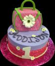 Daisy Purse 1st Birthday cake,  Purple buttercream iced,  round decorated with daisies, pearls, edible pink print wrap and topped with a pink purse. Everything on this cake is EDIBLE.  (Serves 8-80 party slices)