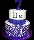 Purple Zebra 7th Birthday Cake,  White buttercream iced, 2 round tiers decorated with a fondant bow, pearls, rhinestones and an edible zebra stripe wrap. Everything on this cake is EDIBLE, except the rhinestones.  (Serves 28-55 party slices)