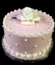 Rose and Pearls Birthday Cake. Pink buttercream iced, round decorated with white pearls and topped with a white rose. Everything on this cake is edible. (Serves 8-80 party slices.) 