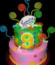 Swirly 9th Birthday Cake. Pink and green buttercream iced, round 2 tiers decorated with plastic swizzle sticks, swirls, stars, dots and circles. Everything on this cake is edible except the plastic swizzle sticks. (Serves 28-55 party slices.) 